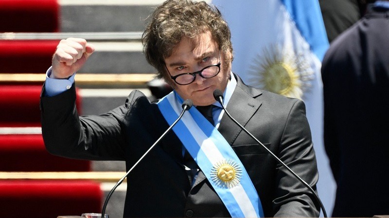 Argentina’s new president Javier Milei gestures as he delivers his inaugural speech before the crowd, during an inauguration ceremony at the Congress in Buenos Aires on December 10, 2023. Libertarian economist Javier Milei was sworn in Sunday as